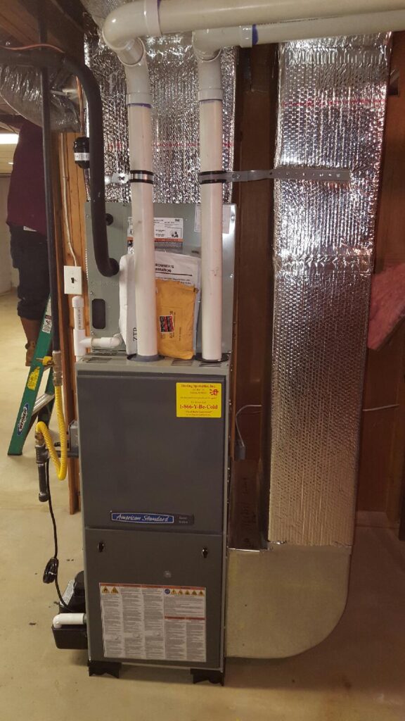 Technician from Heating Specialties Inc servicing a residential furnace system
