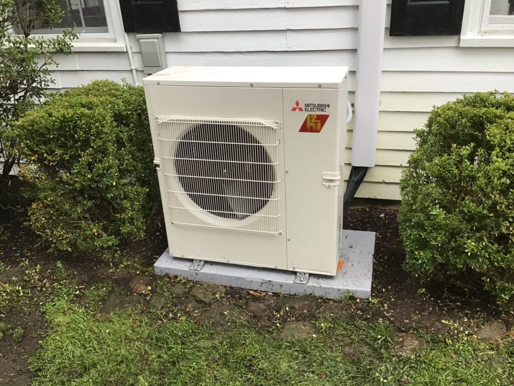 Technician servicing geothermal heating system during maintenance project for Heating Specialties Inc